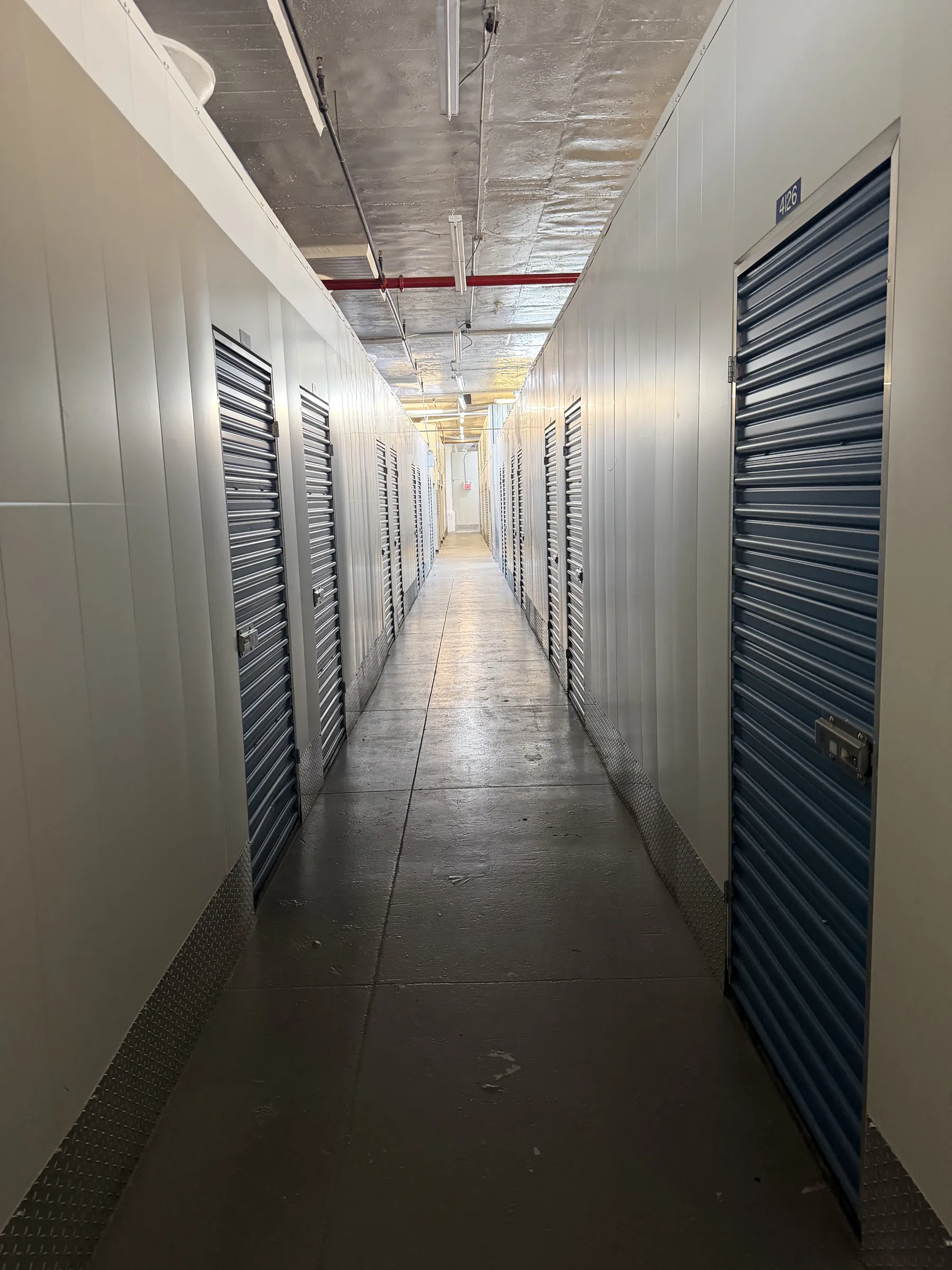 LIC corridor, wide, roll-up doors, practical lighting